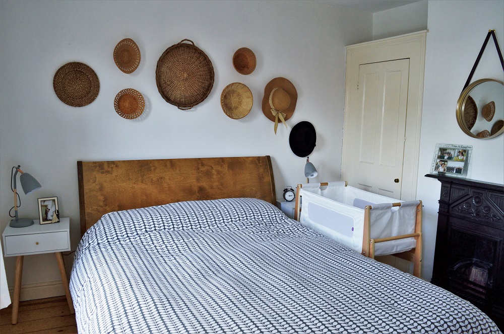Minimalist master bedroom with SnüzPod bedside crib