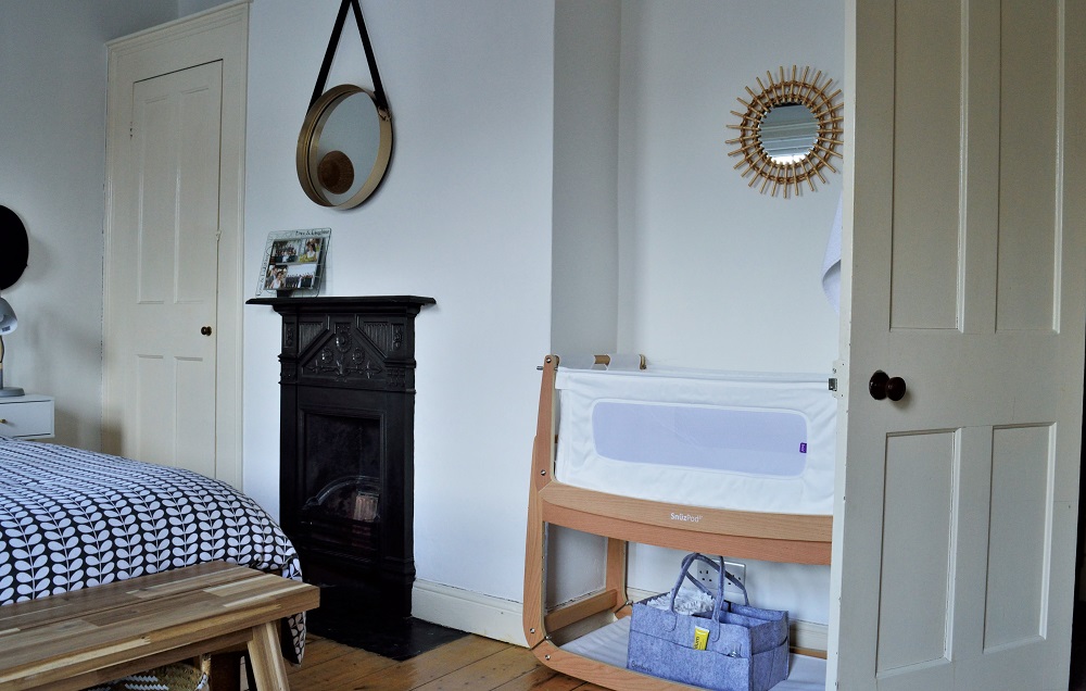 Minimalist master bedroom with SnüzPod bedside crib