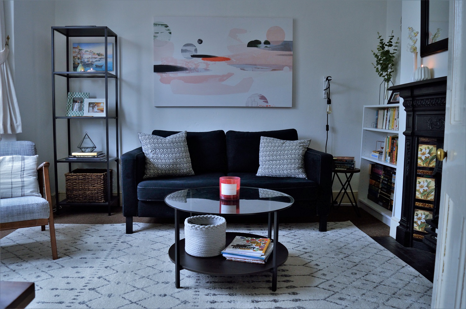 Living room with black sofa and white rug